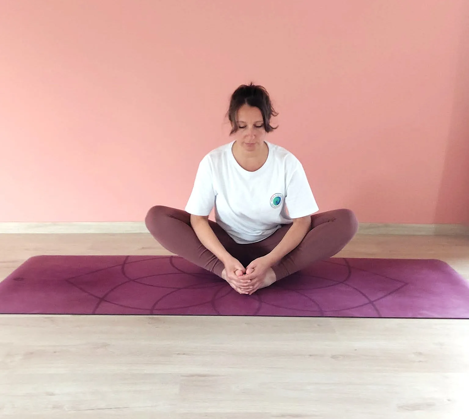 woman in white tank top and black shorts doing yoga on brown concrete floor